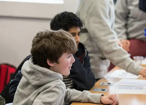 Participants sat at a desk in a workshop