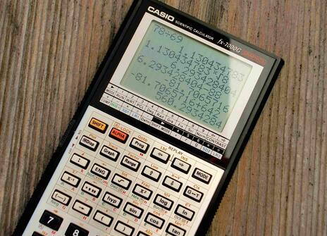 A calculator on wooden surface