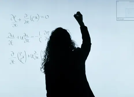 A shadow writes on board