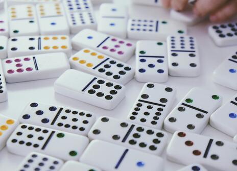 lots of dominoes lie on a white table