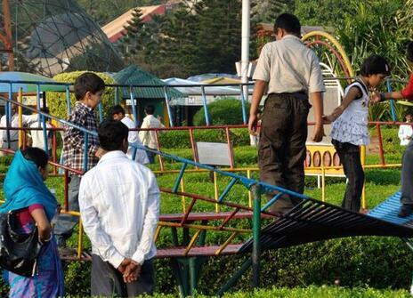 children playing on a playground that is shaped like a mobius band