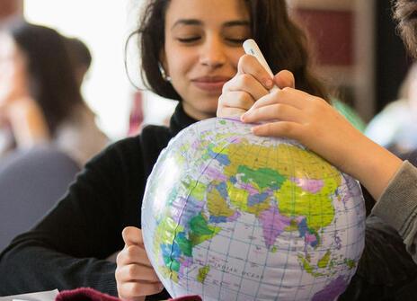 Children are playing with a inflatable globe